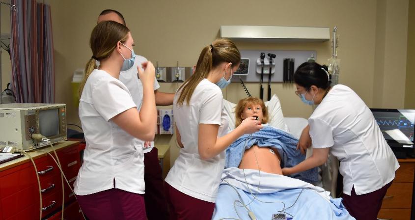 Students practice for a patient in a simulation activity
